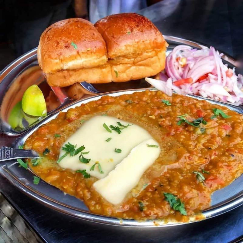 Pav Bhaji is one of the spiciest, vegetarian dish. It is a mixture of boiled vegetables along with a lot of Spices and Onion Coriander mixture for garnish.Fresh and thick slices of bread, smothered in butter served with a delicious mix of moderately spiced vegetables. 
