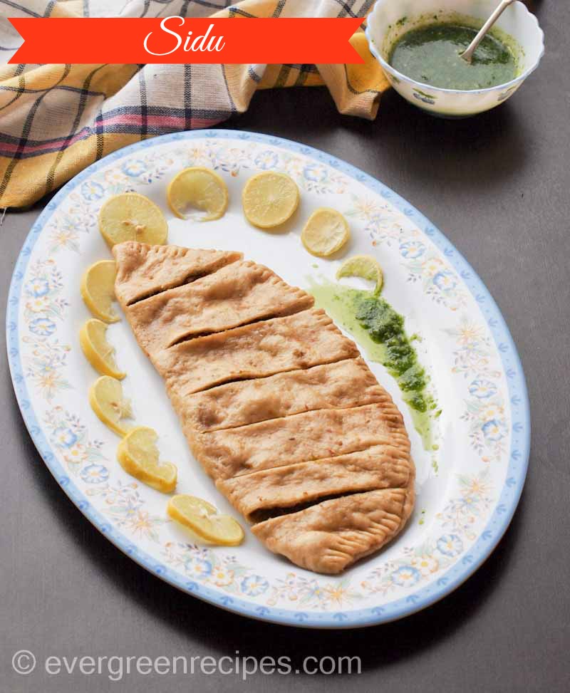 Sidu is a local bread made from wheat flour. The flour is kneaded and set aside for some hours for the yeast to settle and the dough to rise. The dough is put on the bonfire to be par-cooked and then later steamed to complete the cooking. This distinct bread is usually enjoyed with ghee .